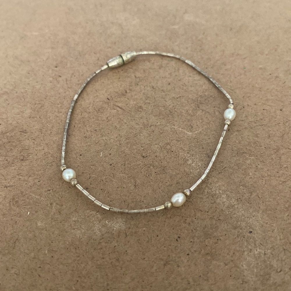 Thin, light silver tone bracelet